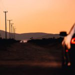 Self-driving Car - A car is driving down a road at sunset