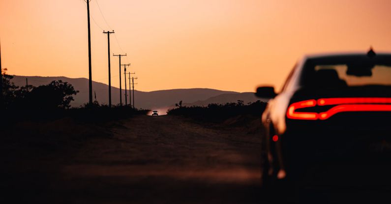 Self-driving Car - A car is driving down a road at sunset