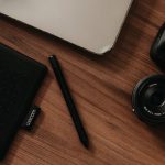 Digital Declutter - A laptop, camera, and other items on a desk