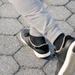 Fast Boot - Crop man running on asphalt road
